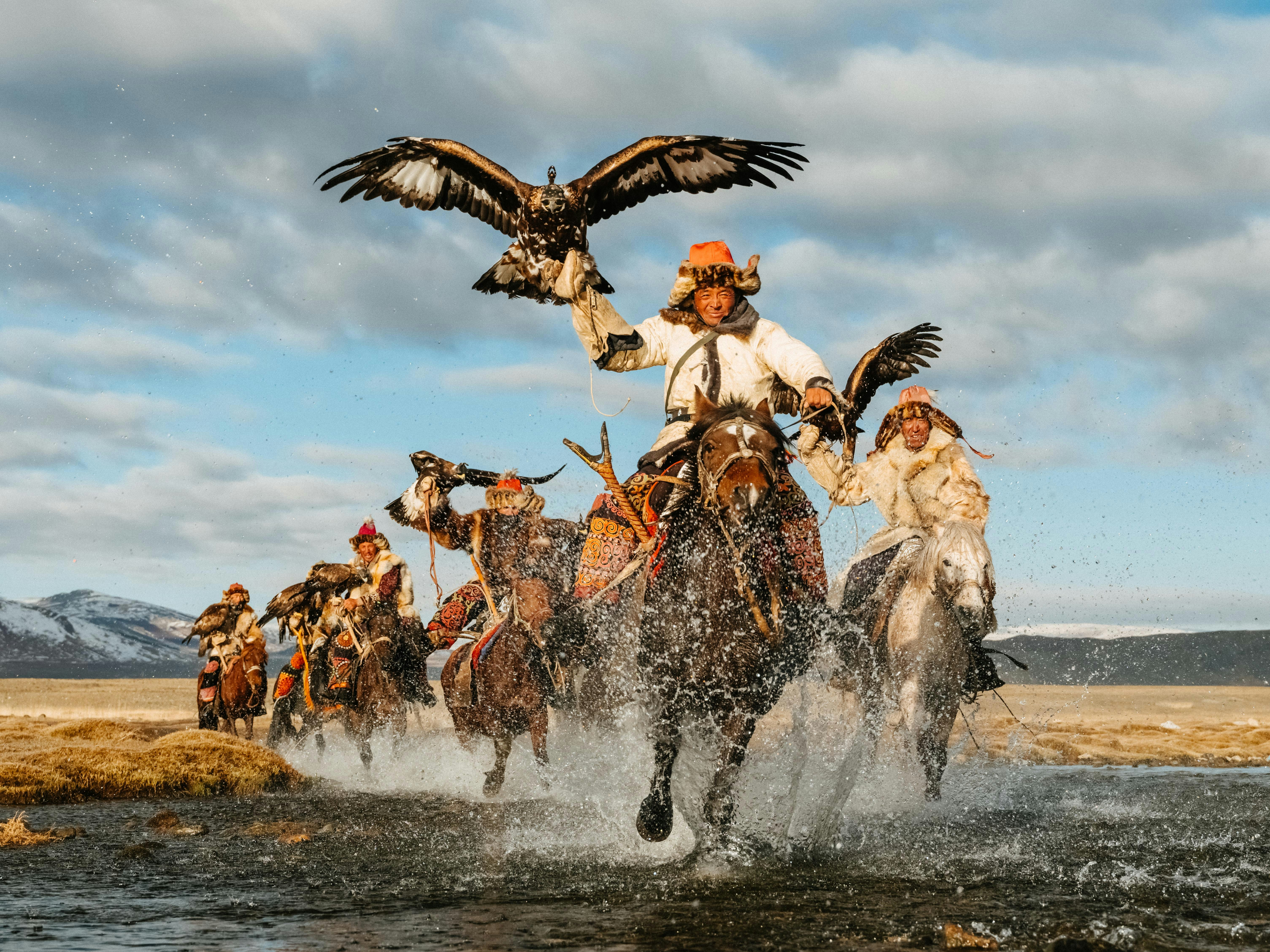 Mongolian eagle hunters on horseback