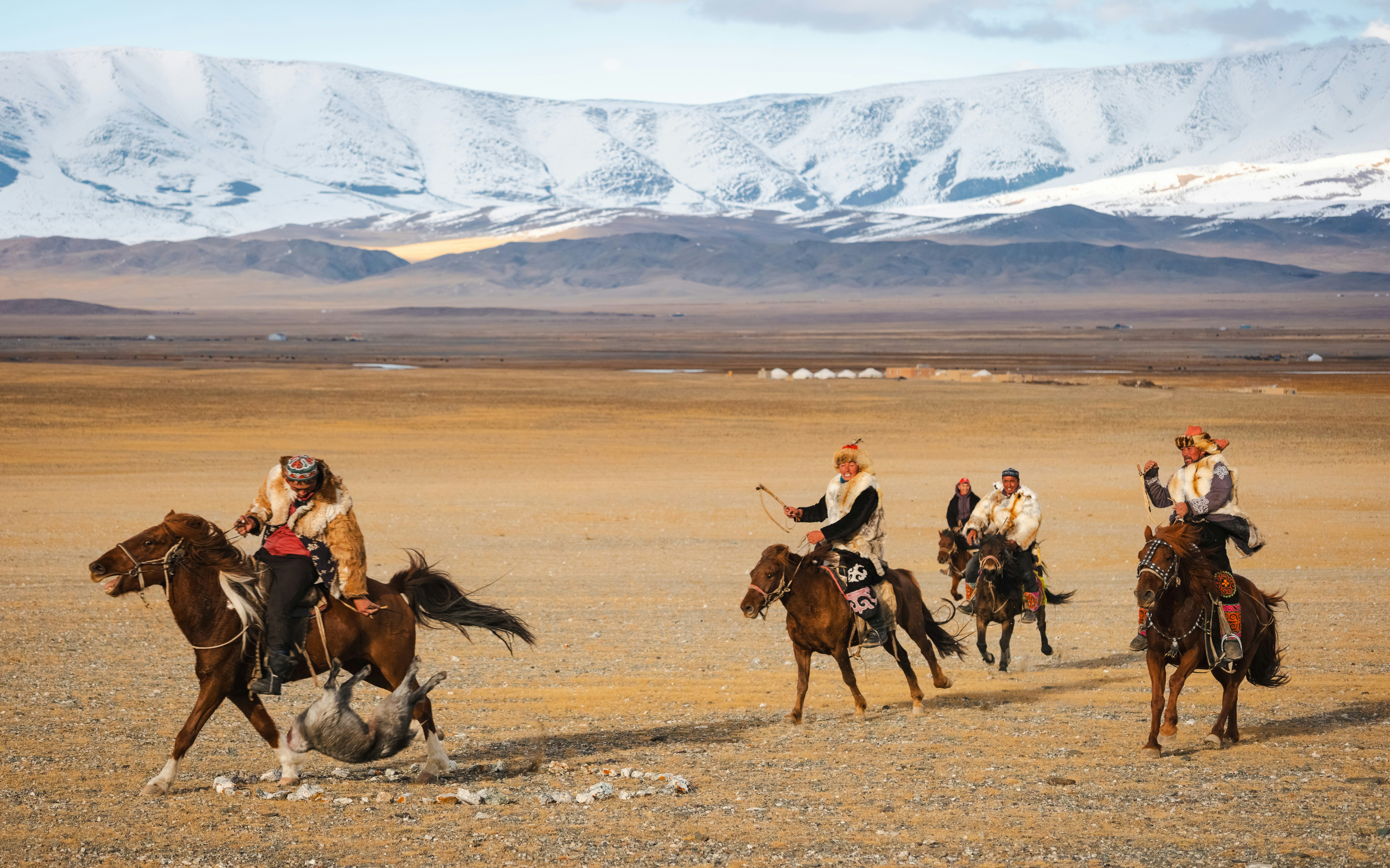 Mongolian riders galloping across the steppe